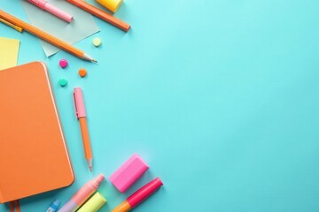 Fototapeta premium A vibrant collection of colorful stationery items arranged on a light blue background, perfect for back to school or educational themes.