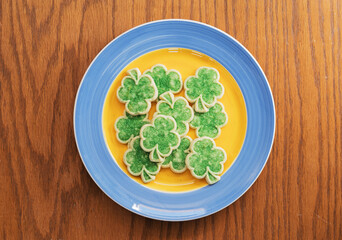 Green Shamrock Sugar Cookies On Yellow And Blue Plate
