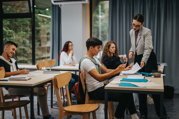 A group of students attentively participates in a classroom setting while a teacher provides...