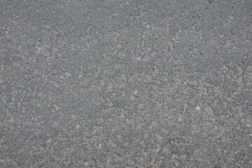 A grey and white road with a lot of gravel