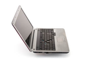 Old, grunge  laptop computer isolated on a white background