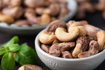 Cashew nuts in bowl closeup view. Unshelled whole asian cashews
