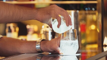 Closeup bartender hand in poring fresh soda gas texture into glass of drink advertisement serving customer at beverage bar counter luxury pub for welcome impression greeting guess service. Vinosity.