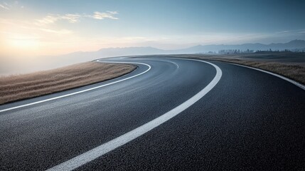 Scenic Winding Asphalt Road at Sunrise through Mountain Landscape