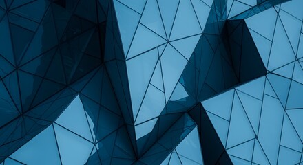 Fototapeta premium Geometric architecture with blue glass facade reflecting daylight patterns