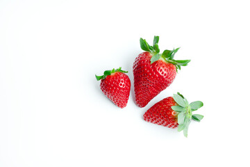 Three fresh strawberries isolated on a white background, highlighting their vibrant red color and natural texture. Perfect for food marketing, healthy lifestyle visuals, and fresh produce promotions.