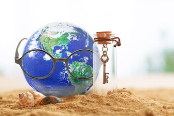 Earth wearing glasses sitting on sand  beach with glass bottom with love key in side, Find Love and Save the World concept, Earth day concept, Elements of this image furnished by NASA