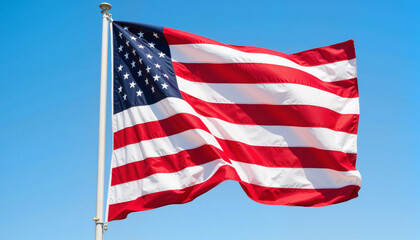 Obraz premium Waving American flag against clear blue sky, symbol of freedom
