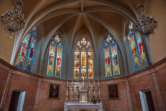 Interior of the church in the town of Arnay le Duc in Burgundy, France, with its stained glass windows and altar