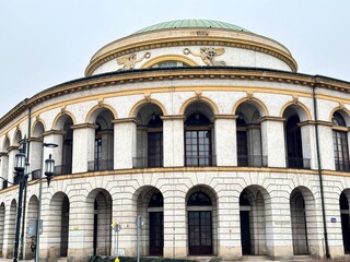 view of an old building with historical architecture with a dome on a Warsaw street on a cloudy winter day

