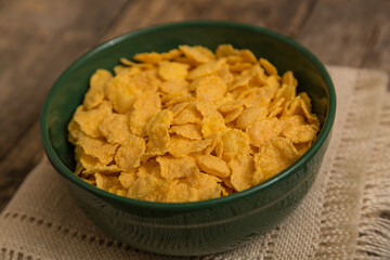 Cereal flakes on a wooden background. Sugary cereal on a old wooden background
