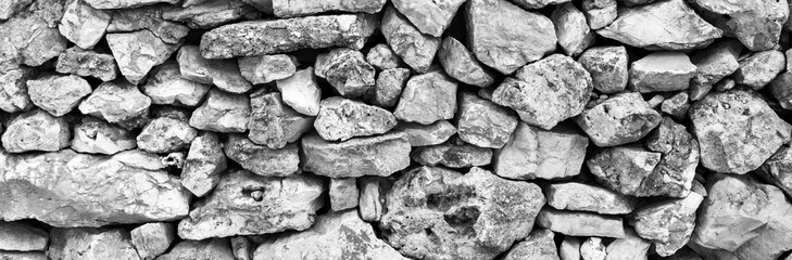 Texture of rock natural wall surface in gray tones with selective blur.