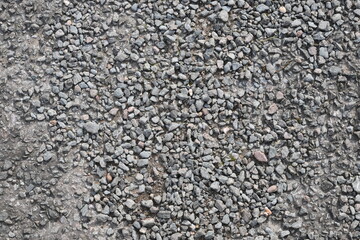 A close up of a rocky surface with a lot of small rocks scattered around