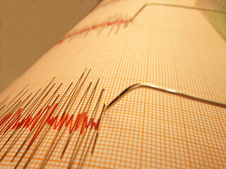Seismograph and earthquake. A seismograph that records the seismic activity of an earthquake.