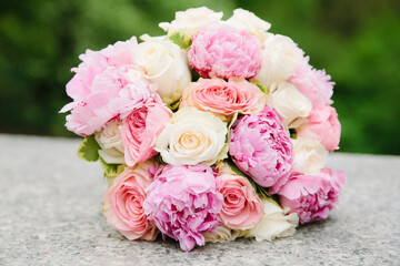 Beautiful bouquet of pink and white flowers arranged elegantly for a special occasion in a garden setting