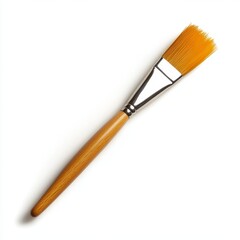 Fototapeta premium A wooden paintbrush with a yellow handle and a silver tip. The brush is laying on a white background