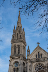 Obraz premium Stunning architectural details of a historic church against a bright blue sky in the heart of an old town