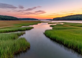 Sunrise over tranquil marsh waterway