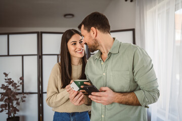 couple use credit card and mobile phone for online shopping at home