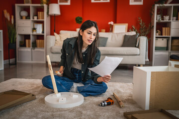 focus woman install small table with instructions at her new home