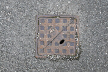 A metal grate is sitting on the ground
