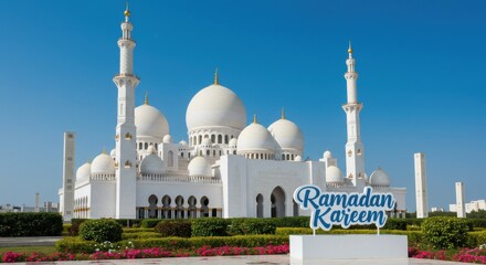 Obraz premium A stunning mosque set against a clear blue sky with multiple domes including a large central dome and two tall minarets there is a sign with the text Ramadan Kareem written in blue elegant font