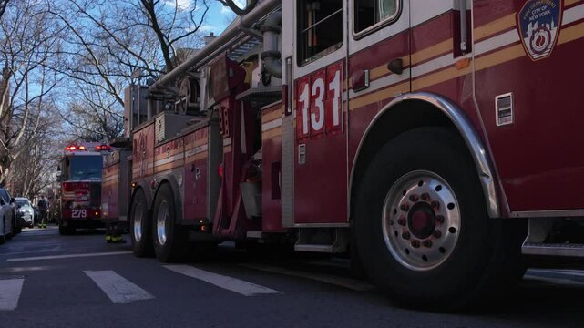 closer shot of flashing New York City firetrucks facing right