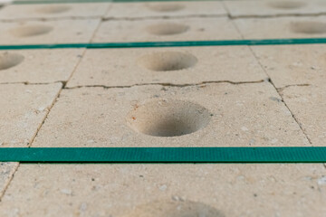 Construction materials showcase the unique texture and design of concrete blocks with circular...
