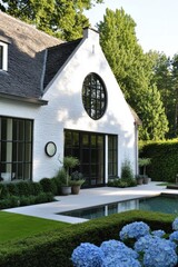 Beautiful modern house surrounded by lush greenery and purple hydrangeas in a serene outdoor setting during the afternoon