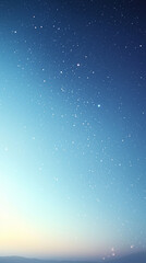 Starry night sky over distant mountains during early dawn