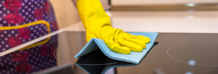 Housewife cleaning gas stove, cleanliness concept