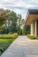 Naklejka premium A breathtaking modern landscape features a charming stone pathway surrounded by vibrant greenery, creating a serene outdoor atmosphere illuminated by the golden hour's warm light