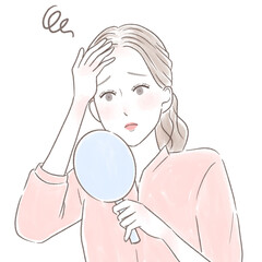 手鏡を見て髪の生え際の白髪が気になる女性