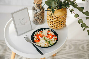 Vegetable salad in a round black plate