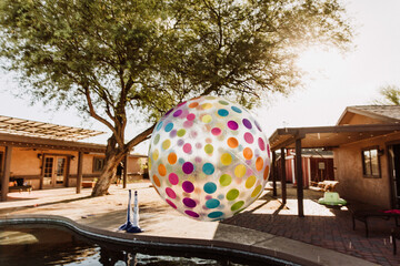 Beachball floating over swimming pool