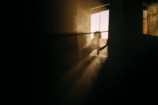 silhouette of a woman in a window