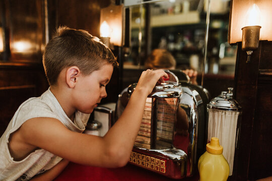 Boy in Diner looking at juebox