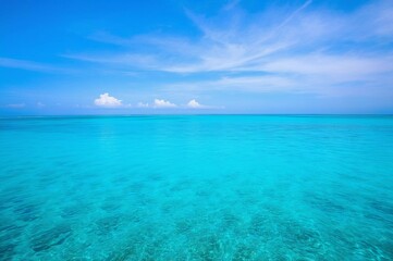 blue sky with white clouds over a turquoise sea