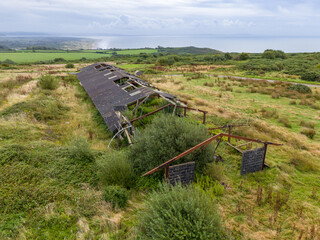 A drone view of a dilapidated building in a field