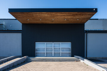 Entrance of a large grey warehouse.