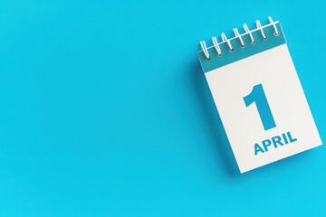 April 1st. Image of april 1 wooden color calendar on blue background. Spring day, empty space for text. All Fool's Day 
