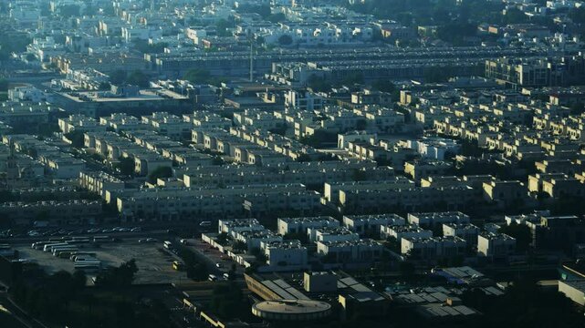 Aerial panoramic view of urban residential area in Dubai in a warm sunset sun, no logos