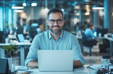 Fototapeta premium A cheerful professional man working on a laptop in a modern office. He appears confident, engaged, and productive, surrounded by contemporary office furniture and technology.