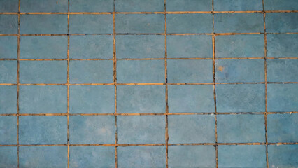 Old, broken blue tile floor
