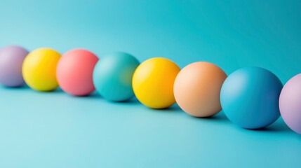 Pastel Colored Spheres in a Row on a Blue Background