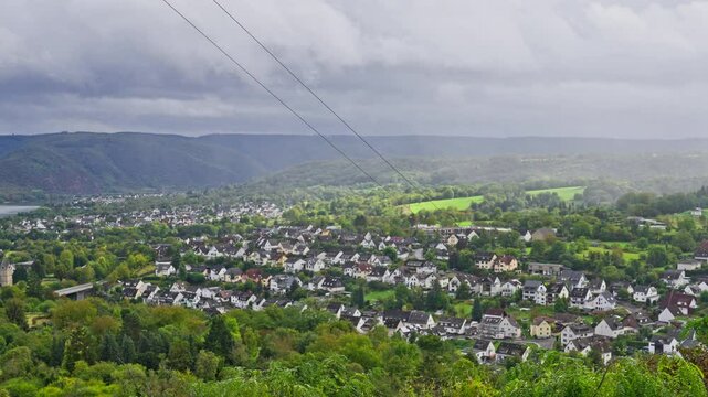 Aerial view over small scenic town of Rhens surrounded by rolling hills in the Rhine Valley, Germany