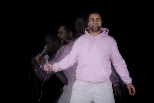 Stroboscopic photo of young man with microphone on dark background