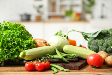 Different fresh vegetables on wooden kitchen counter