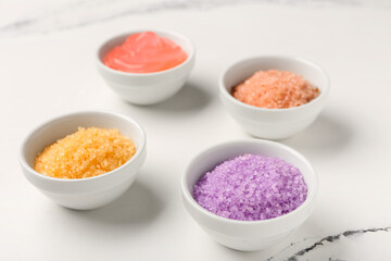 Bowls with scrubs on light background