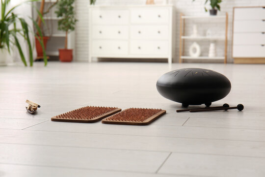 Sadhu board with Palo Santo and glucophone on floor in living room